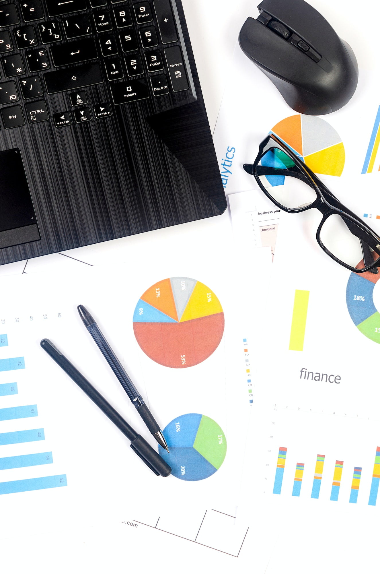 analyzing statistics and results. Charts and graph with financial data, laptop, glasses.